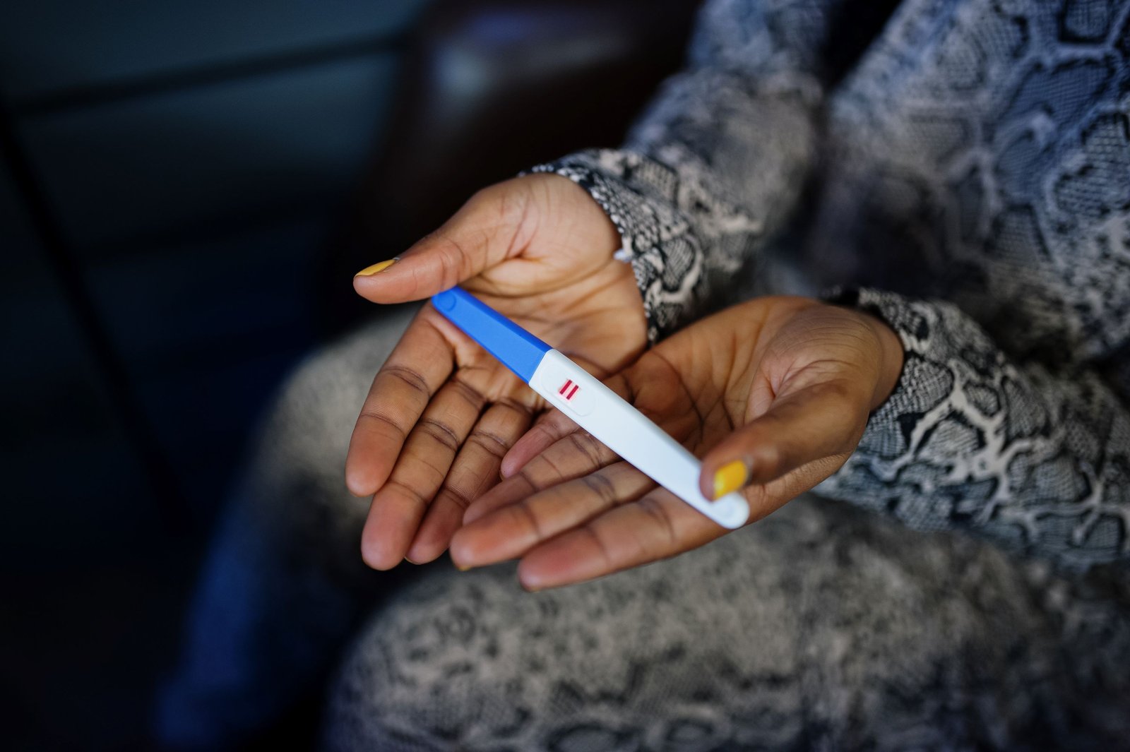Wife holding pregnancy test kit